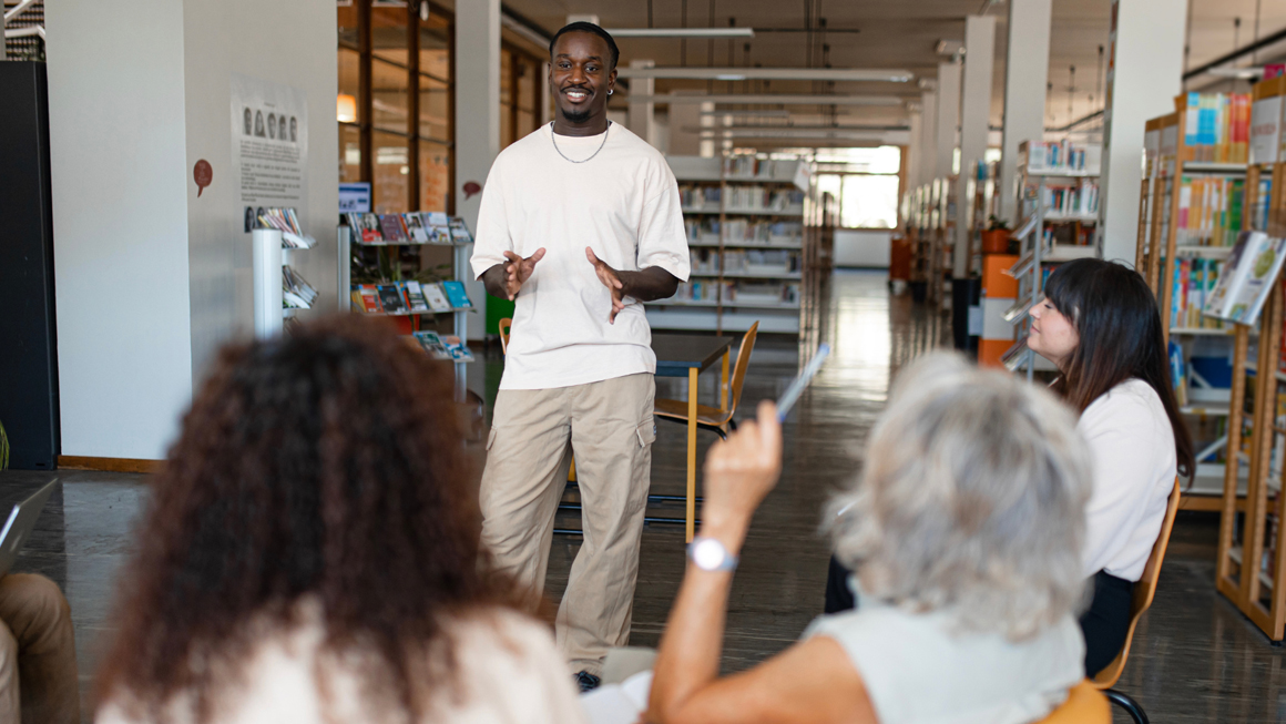 African American man leading discussion at public library